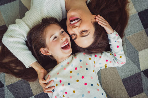 istock Joyful bonding time between mother and daughter on a cozy spring day at home, sharing laughter and relaxation in a living room. 2192777439