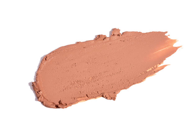 Close up of beauty liquid foundation, concealer stroke on white background