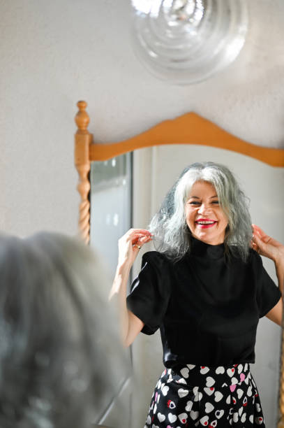 istock cheerful senior woman looking throw window. 2192778393