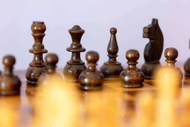 istock Wooden black chess pieces on the chessboard 2192779437
