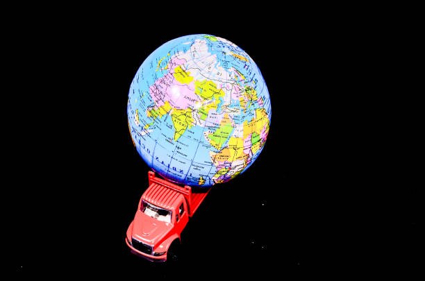 istock A red truck is carrying a globe 2192780245