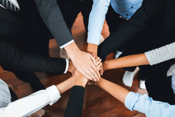 istock Multiracial business people make synergy hand stack together. Habiliment 2192782987