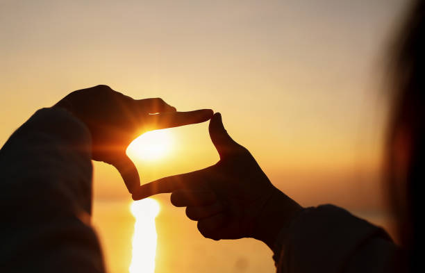 istock Planning and vision, Woman's Hands making frame looking find focus at sunset. 2192783970