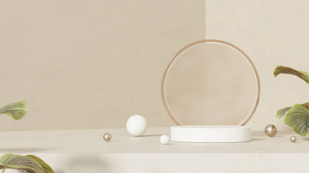 istock Empty mockup showcasing a round podium with a ceramic texture. The podium is accompanied by clear glass on the side, elegantly bordered in rose gold, set against a simple beige wall in a landscape 2192784582