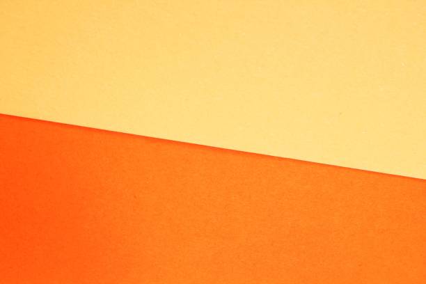 istock Minimalist abstract background a diagonal split between orange and soft yellow. Close-up of a colorful paper texture with a diagonal line dividing two tones. Concept of simplicity, balance and harmony 2192785984