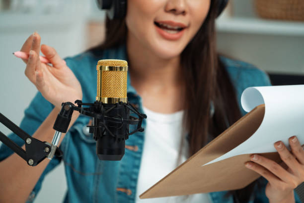 istock Host channel Asian in broadcast wearing headsets with script note. Stratagem. 2192788221