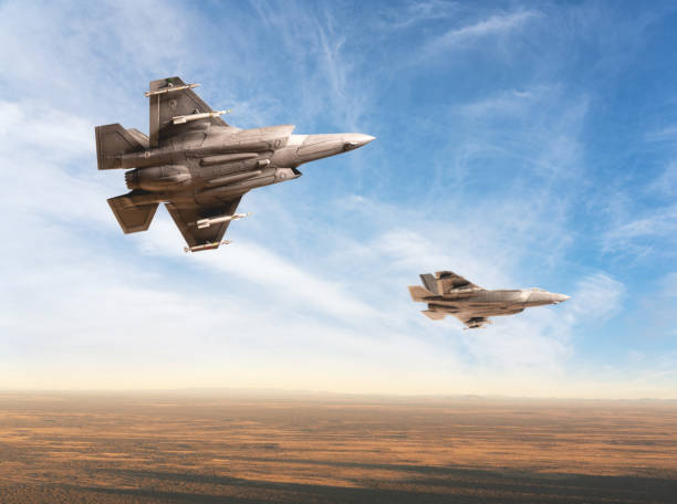 State of the art F-35 A stealth strike fighters in flight above a desert location. Scale model photography.