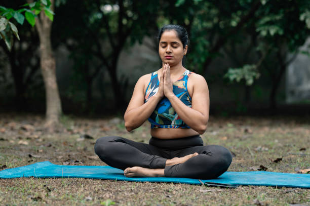 istock Beautiful woman meditating position at park 2192792904