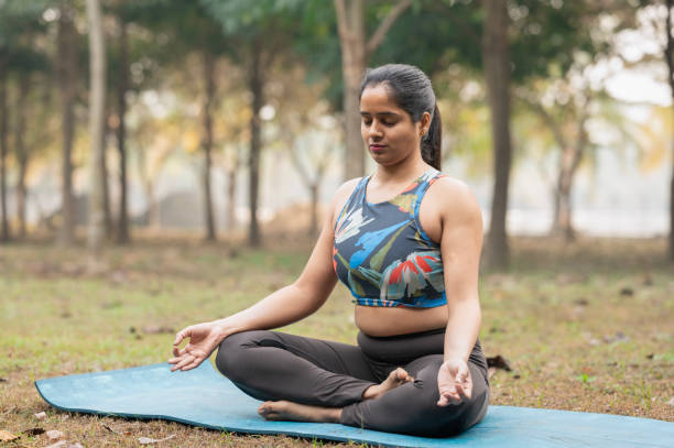 istock Beautiful woman meditating position at park 2192792909