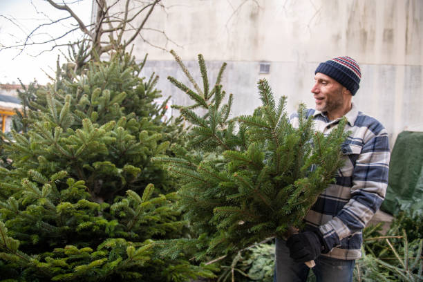 istock Choosing a Christmas tree at the outdoor market 2192793721