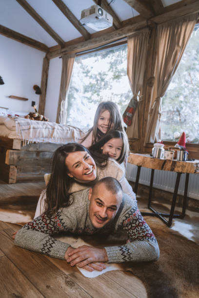 Family making human pyramid at cabin stock photo