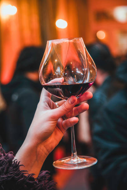 istock Raising a Glass of Red Wine in an Elegant Evening Setting 2192795388