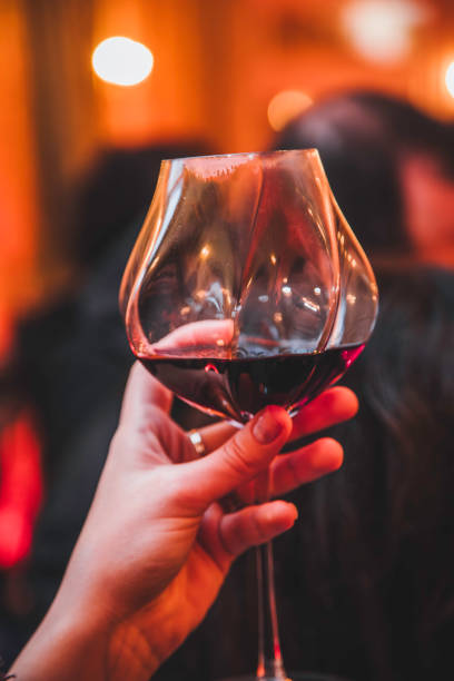 istock Raising a Glass of Red Wine in an Elegant Evening Setting 2192795407