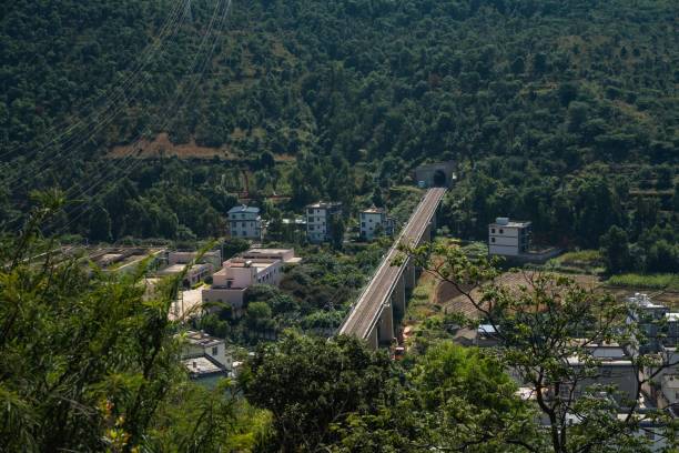istock Scenic railway bridge and tunnel in lush hills. 2192797651