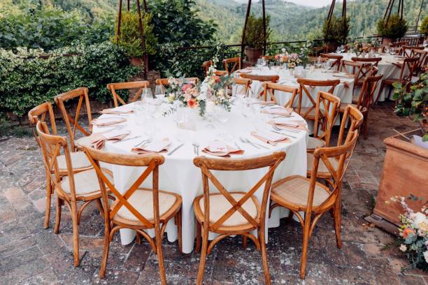 istock Elegant outdoor dining setup with floral centerpieces. 2192799033