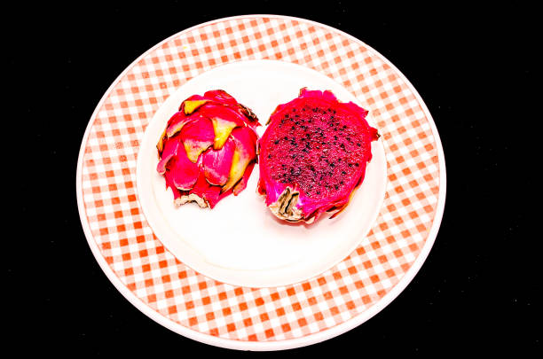 A plate with a piece of fruit on it. The plate is white and red