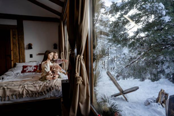 istock Girls playing together on bed next to window 2192799834