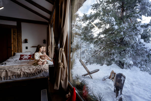 istock Girls playing together on bed next to window 2192799840