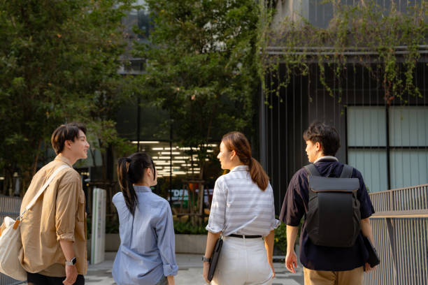 istock Young Employee Engaging in Conversation with Colleagues at Office Park. 2192800874