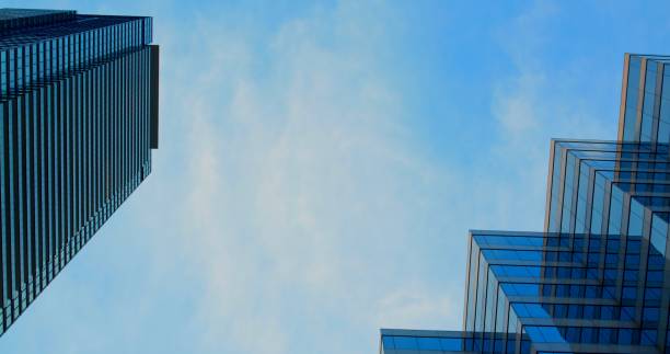 istock Contemporary skyscrapers tower against clear blue sky, impressive innovative architecture. Captivating view of modern skyscrapers against blue sky, urban architecture's elegance and scale. 2192803099