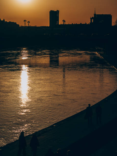 Golden sunset reflected in the river in the city