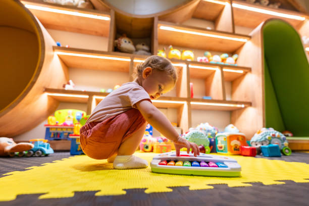 istock Child developing motor skills while playing with a musical toy in a bright playroom 2192806461