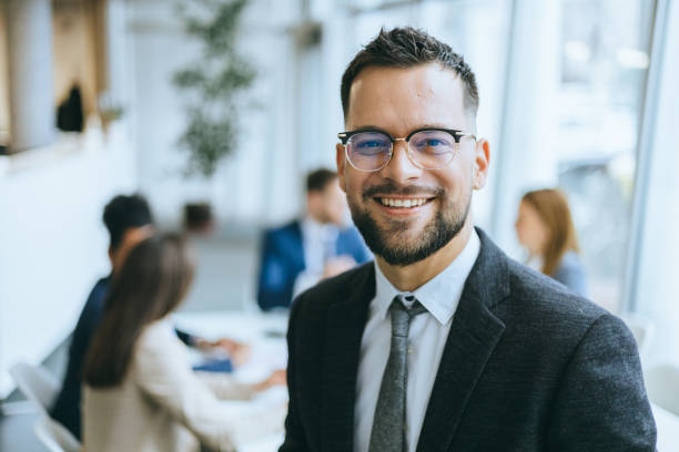istock Smiling executive with coworkers in the background 2192806819
