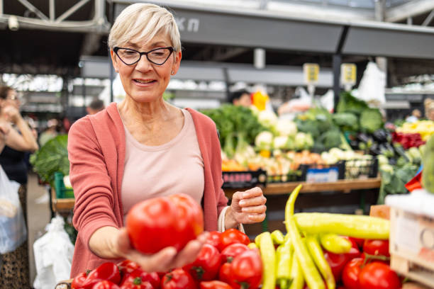 istock Senior woman shopping for fresh tomatoes 2192806894