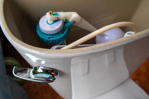 istock Interior of a toilet tank showing components like the fill valve, float assembly, and flush mechanism during maintenance work 2192807018