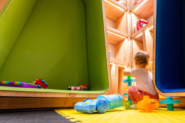 istock Little child enjoying creative playtime with a toy vacuum cleaner in a bright and interactive playroom 2192809736
