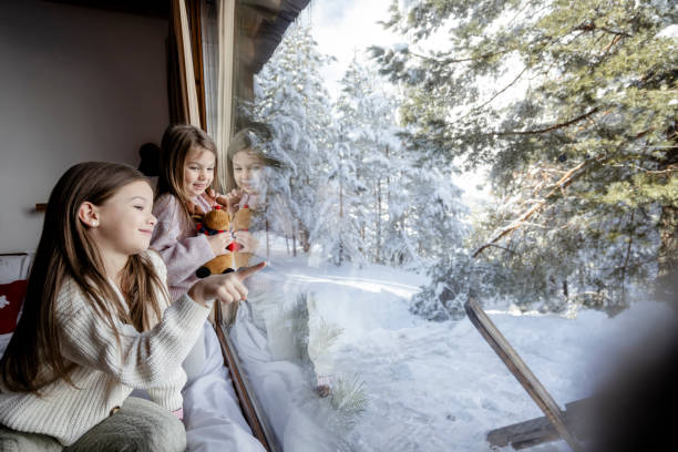 istock Girls playing together on bed next to window 2192810058