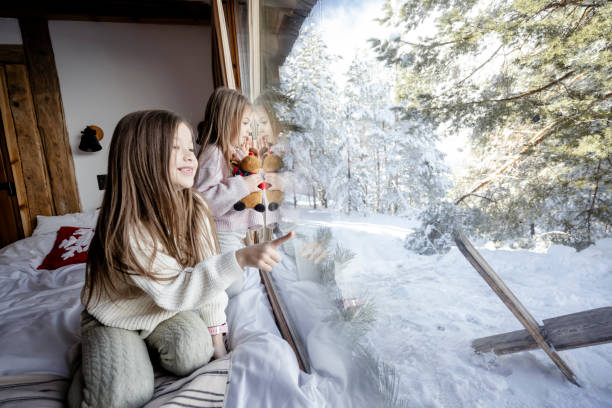 istock Girls playing together on bed next to window 2192810069