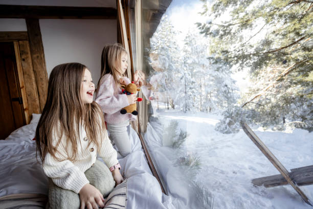 istock Girls playing together on bed next to window 2192810078