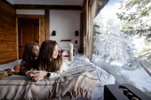 istock Girls playing together on bed next to window 2192810134