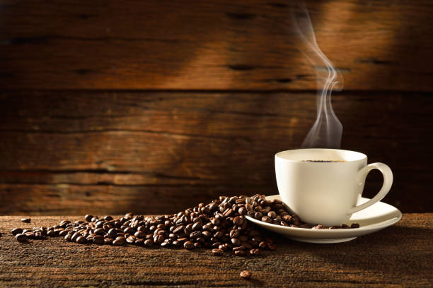 istock Coffee cup and coffee beans on old wooden background 2192810229