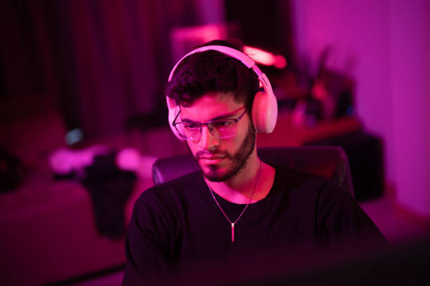 istock Focused gamer immersed in a vibrant gaming environment during a late-night session 2192813240
