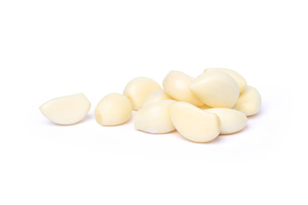 istock Peeled garlic cloves isolated on white 2192813254