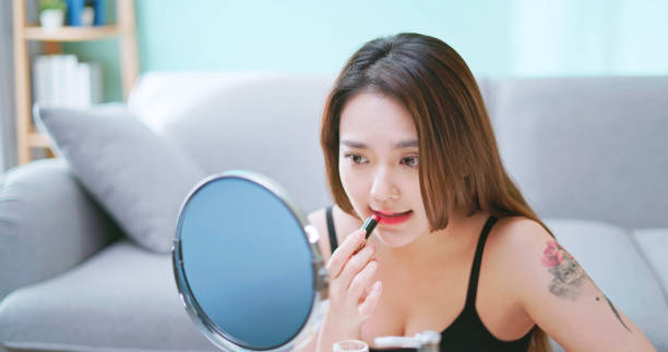 istock asian beauty apply lipstick 2192813627