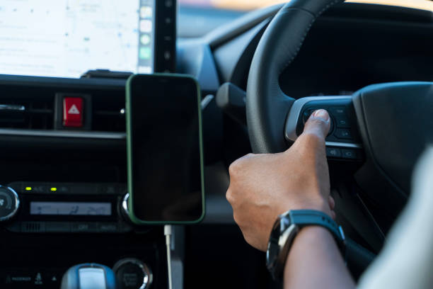 istock The driver presses the cruise control button on the car steering wheel with his hand. 2192814114