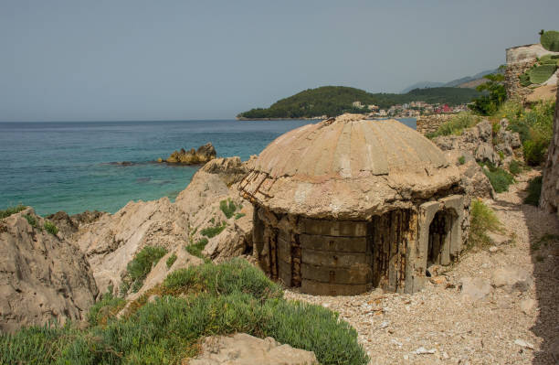 An abandoned pillbox bunker on Potam Beach in Himare Bay on the Albanian Riviera. Some of the building materials have been stripped away from it and repurposed. A relic from the 1960s -1980s Hoxha government's bunkerization program driven by a fear of invasion