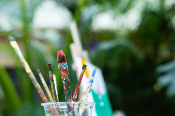 Bright blue paint being mixed with a brush for an art project.