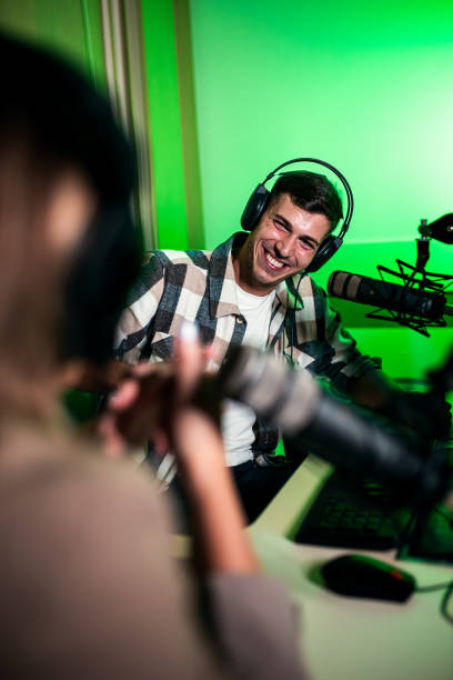istock Male podcaster making podcast with young woman from his studio. 2192819230