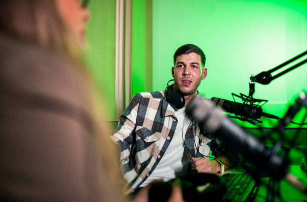 istock Male podcaster making podcast with young woman from his studio. 2192819245