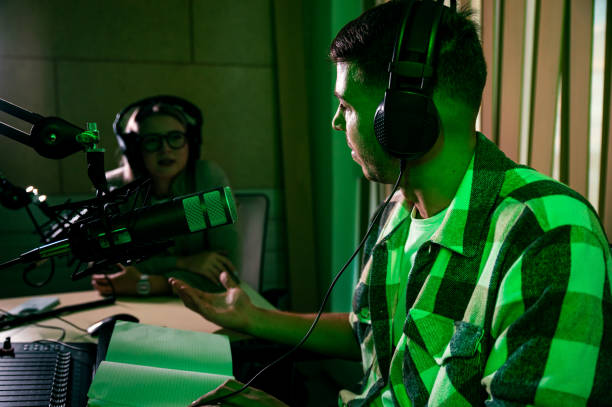 istock Male podcaster making podcast with young woman from his studio. 2192819294