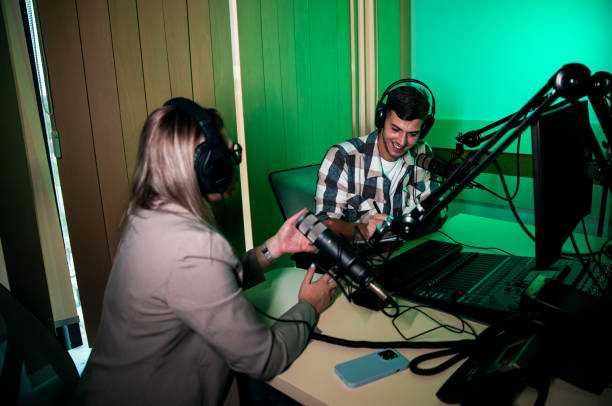 istock Male podcaster making podcast with young woman from his studio. 2192819300