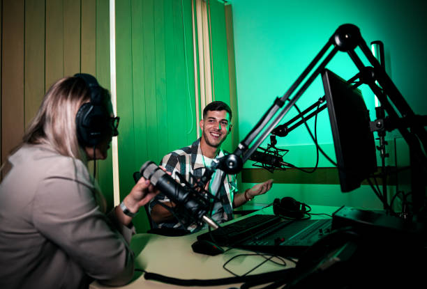 istock Male podcaster making podcast with young woman from his studio. 2192819317