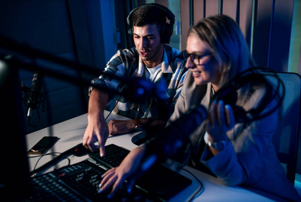 istock Young woman and man editing audio podcast in their studio. 2192819346