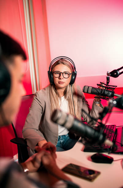 istock Female podcaster making podcast with young man from her studio. 2192819432