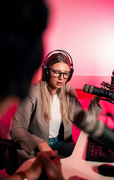 istock Female podcaster making podcast with young man from her studio. 2192819436
