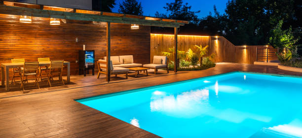 istock Evening poolside view with dining and lounge area on a wooden deck 2192821692